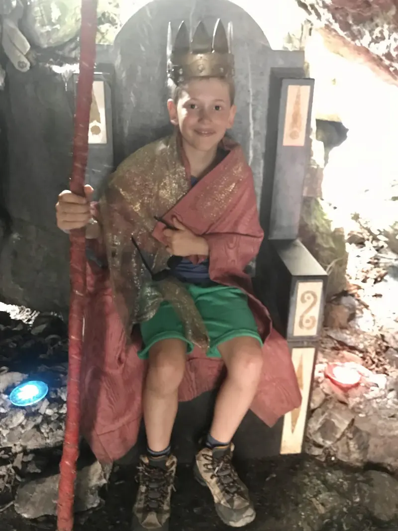 A king on a throne in a cave