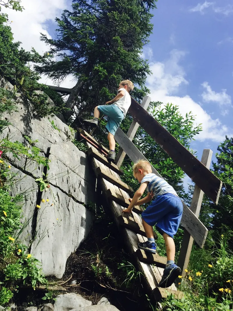 Climbing a wooden ladder up the rock