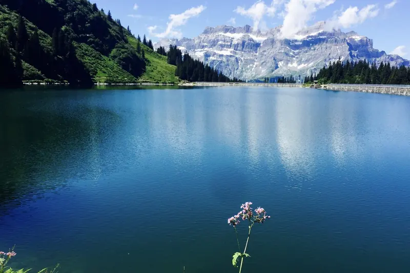 A deep blue lake with a mountain massif behind