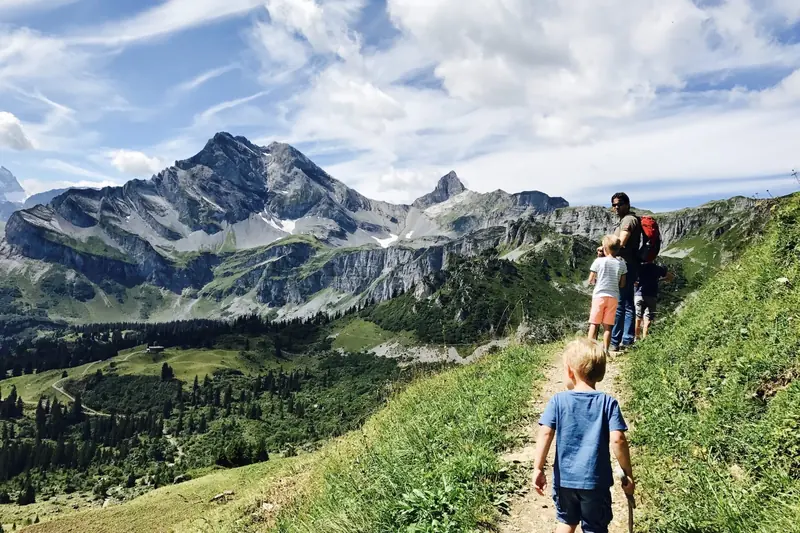 Children on a mountain path, a high peak in the distance